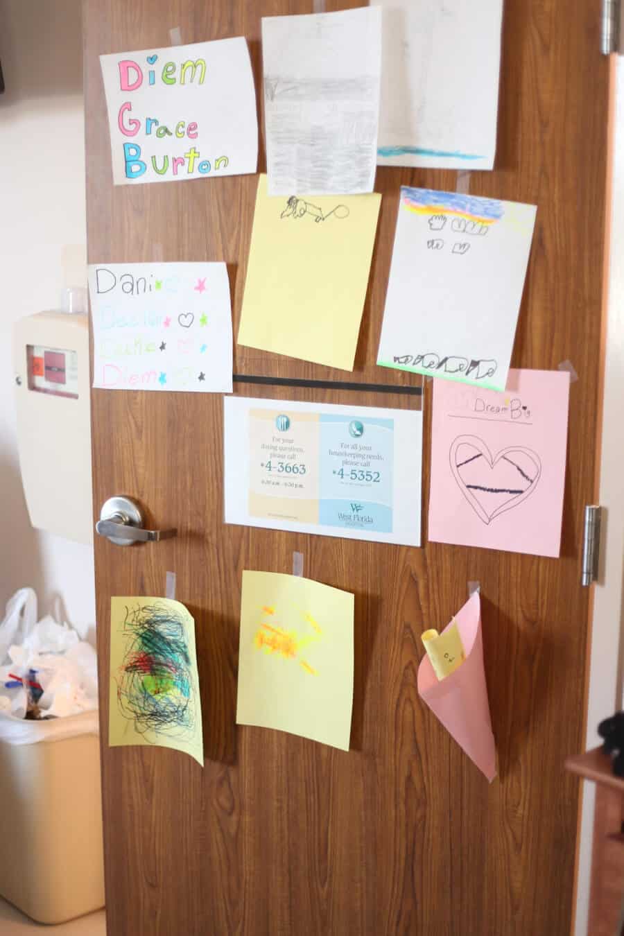 Notes and pictures the siblings drew for their mom are taped on the hospital door.