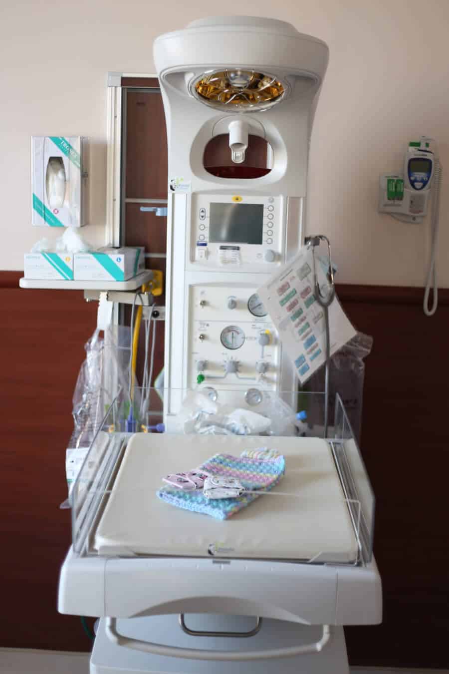 Warming station at the hospital for newborns that was never used. Crocheted blanket and hand sewn small diapers for stillborn baby.