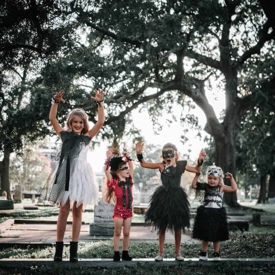 Four girls in a cemetery dressed up for Halloween