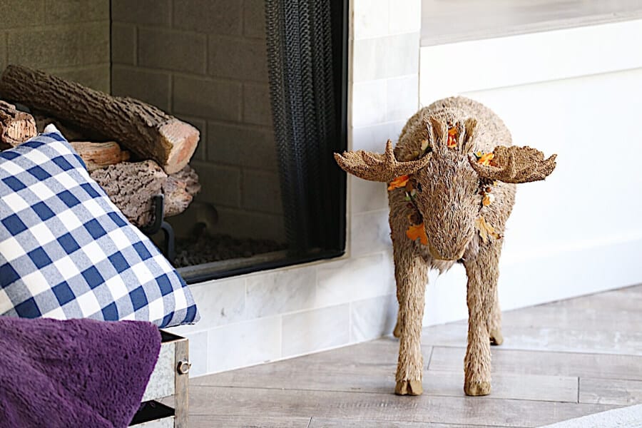 Fall Moose in front of a fireplace