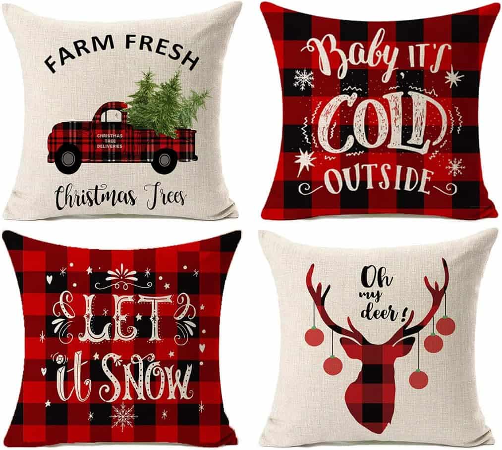 Festive holiday pillows featuring Christmas trees, snow, and reindeer with red and black plaid patterns for cozy winter decor.