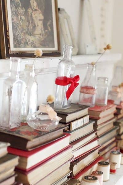 Simply turn books around and stack them. Add small vases and tie red ribbon to make this a Valentine's Day Decor item. #valentinesdaydecor #valentinesday