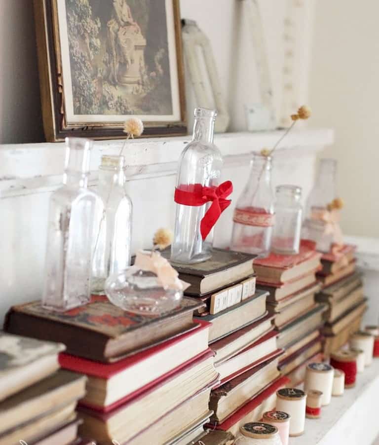 Simply turn books around and stack them. Add small vases and tie red ribbon to make this a Valentine's Day Decor item. #valentinesdaydecor #valentinesday