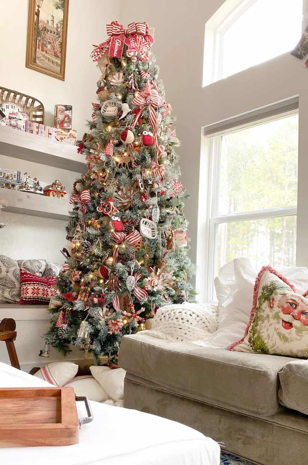 Christmas Tree in the family room with a Chunky knit throw on the couch.