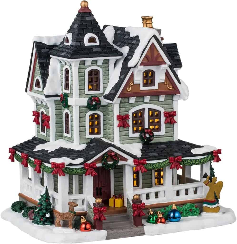 Ornamental Christmas house with festive decorations and snow accents, ideal for holiday decor and collectible displays.