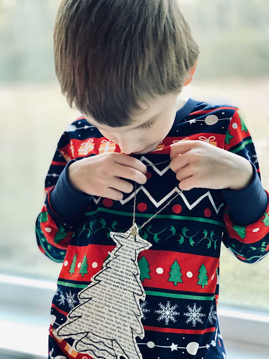 Boy looking down at hand made Christmas ornament.