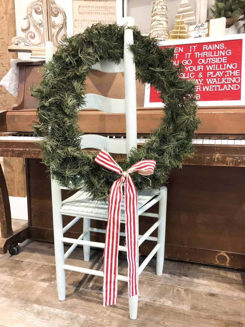 Dark Scandinavian Christmas Wreath with simple ribbon tied into a bow.