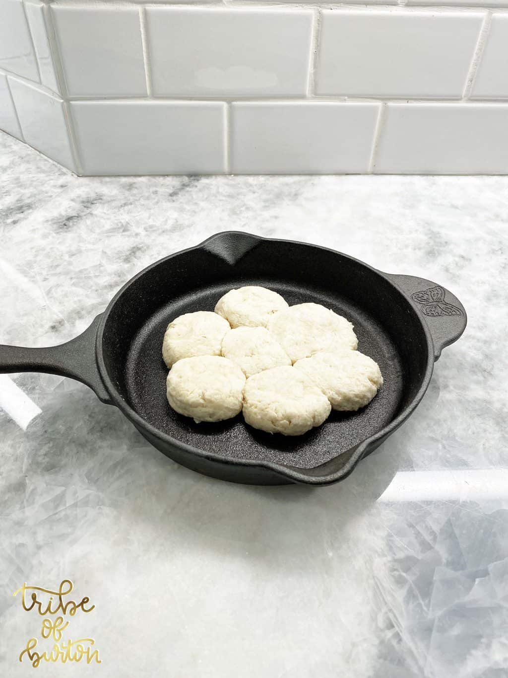 Skillet with homemade buttermilk biscuits ready to go in the oven.