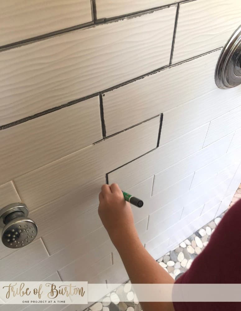 Coloring in white grout lines with grey grout marker.