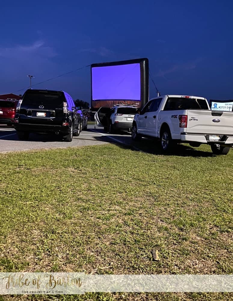 Lights are about to be turned off - looking at the screen at the drive in movie theater.