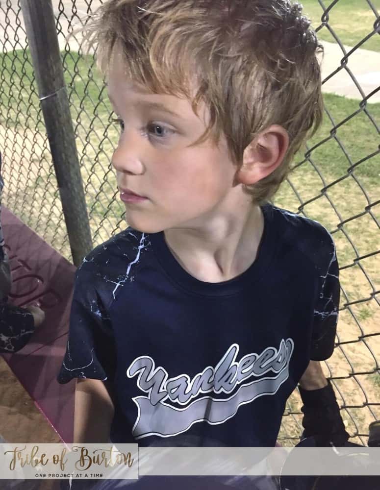 Boy in Dugout watching the game.