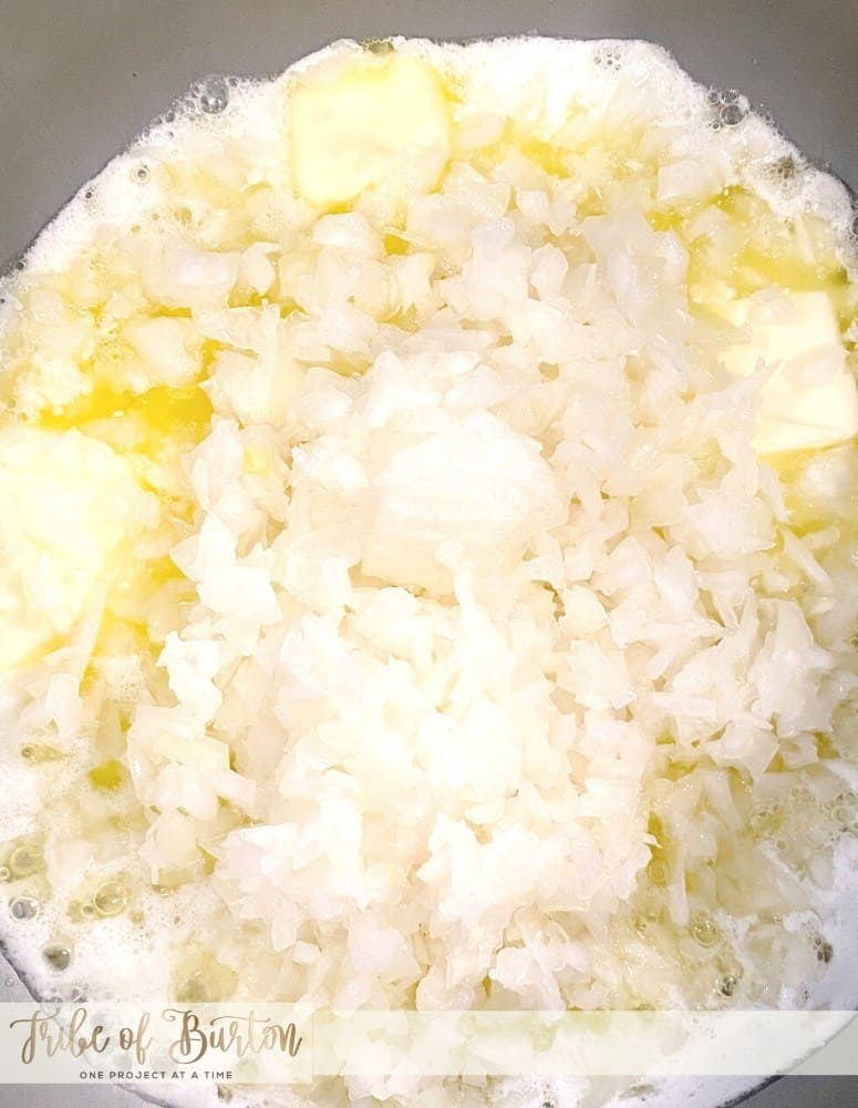 Onions cooking in butter in a pot.