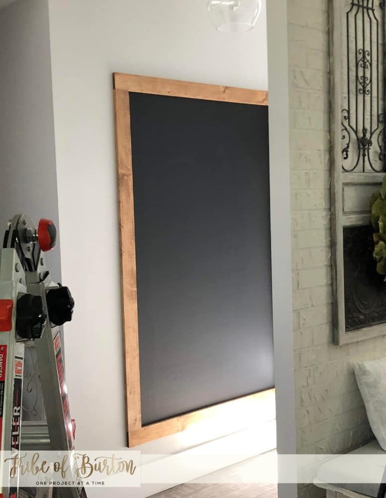 Chalkboard Wall with a stained wood frame around it.