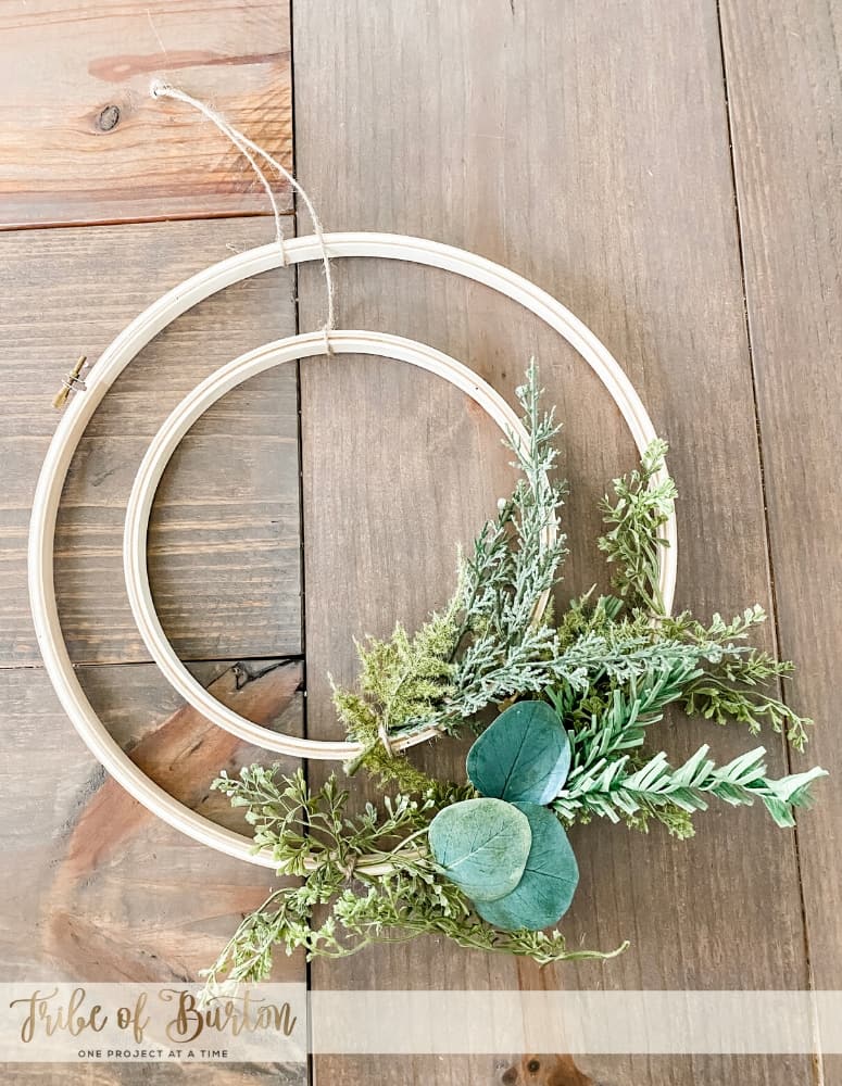 Hoop Wreath laid out on the table with greenery