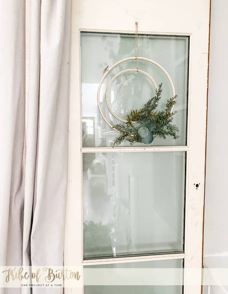 Embroidery Hoop Wreath on an old white door with glass.