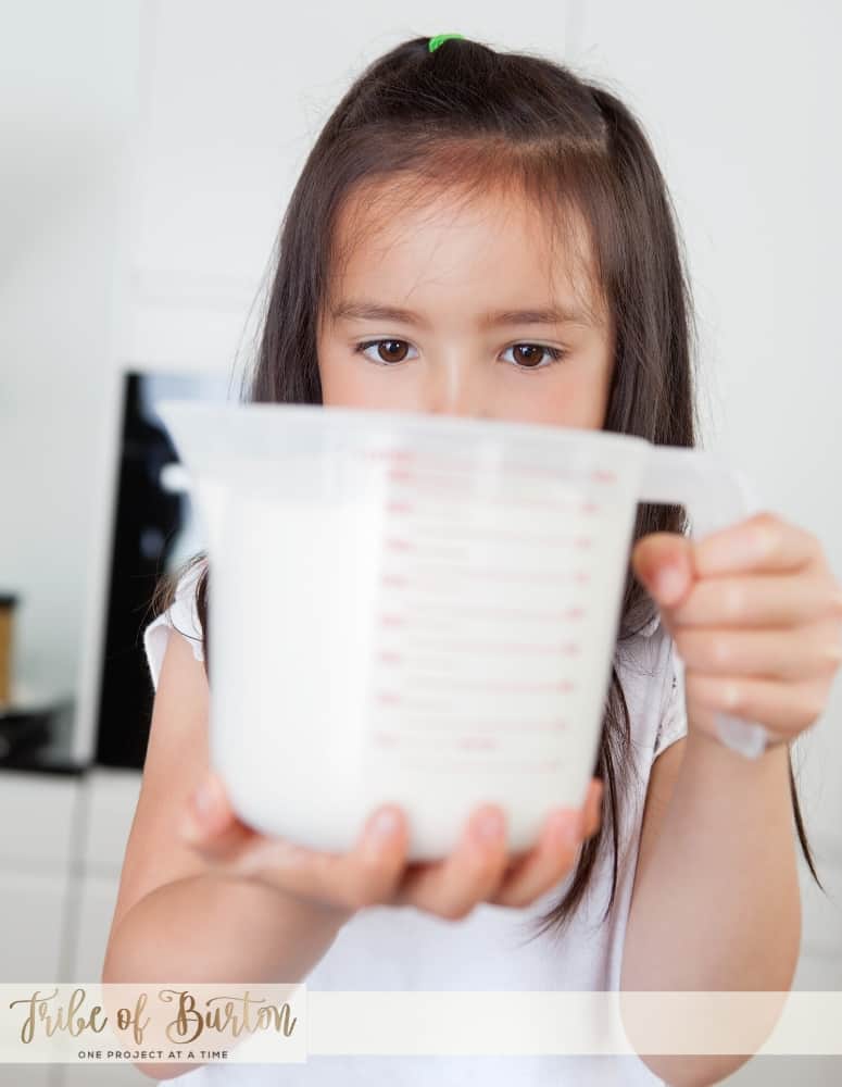 A little girl with a measuring cup