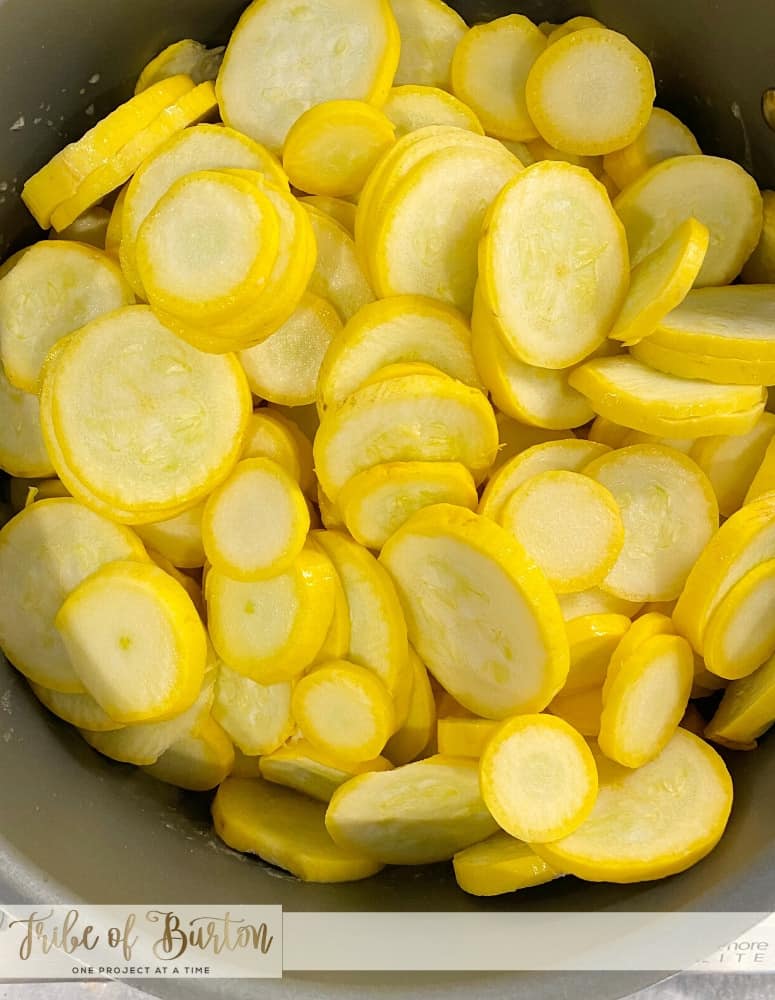 Picture of sliced yellow squash in a pot on a stove.