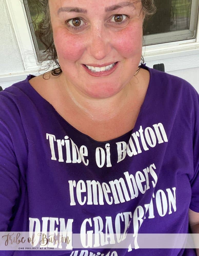 Girl in purple shirt sweating after working out