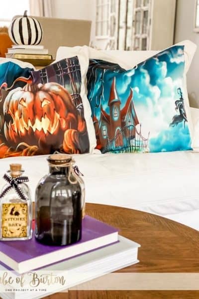 2 halloween pillow cases on white courch