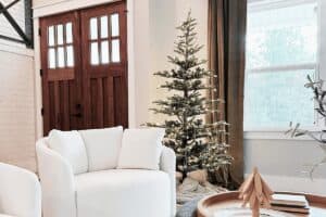 Cozy living room with a decorated Christmas tree and modern decor, perfect for holiday celebrations and home comfort.