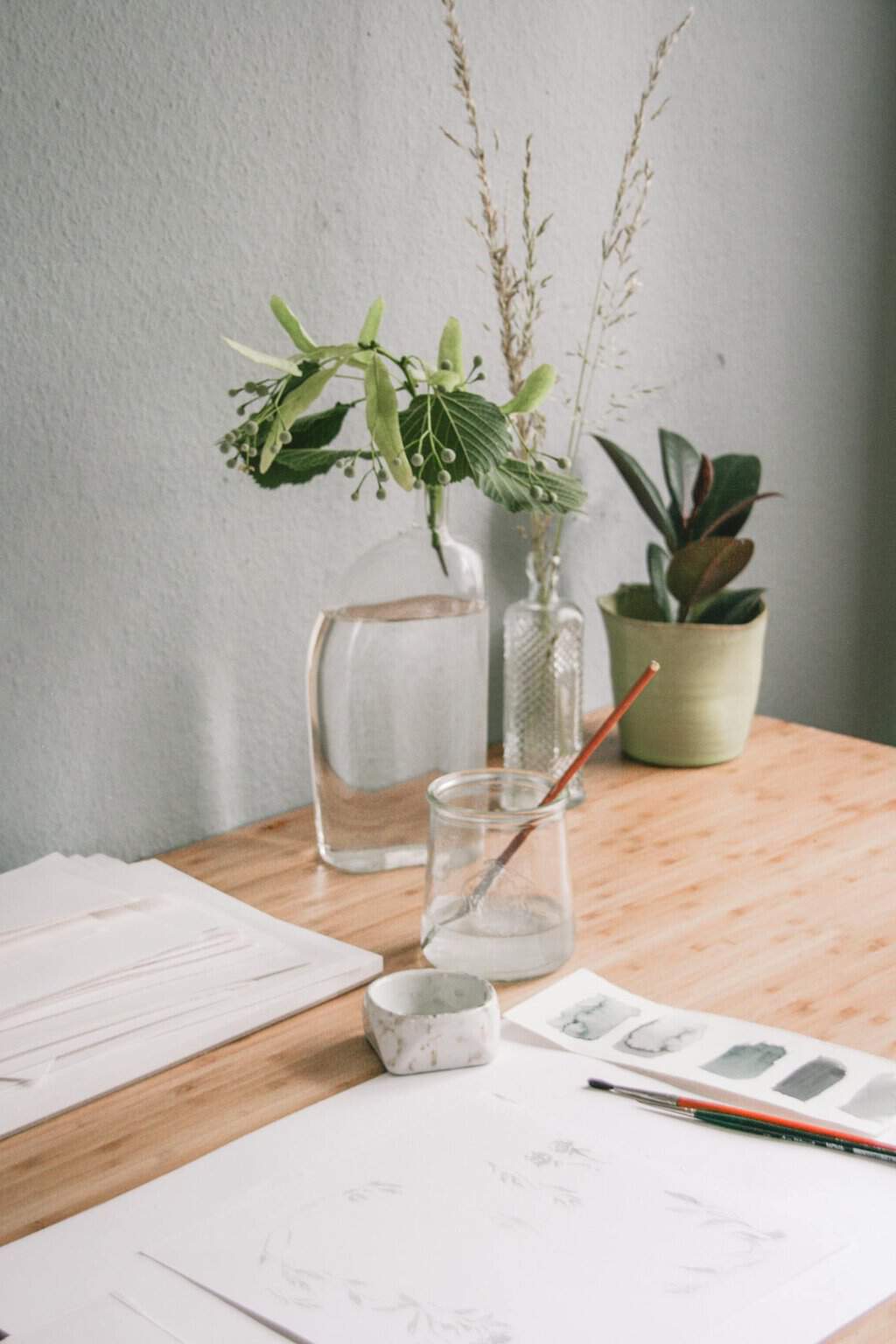 Green plant and botanical decor in modern minimalist workspace.