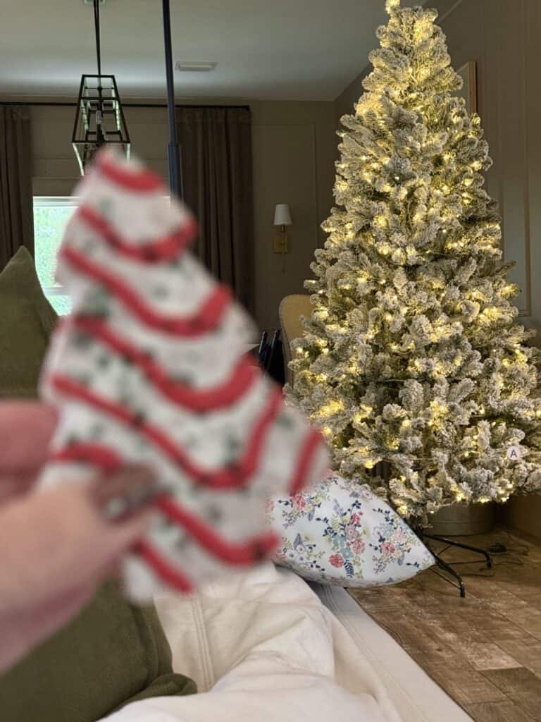 Little debbie christmas tree in front of warm white lights kind of christmas